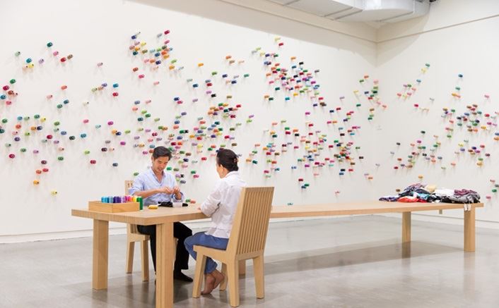 Lee Mingwei, The Mending Project, 2009–present. Mixed media interactive installation: tables, chairs, thread, fabric items, dimensions variable. Photo courtesy of Taipei Fine Arts Museum