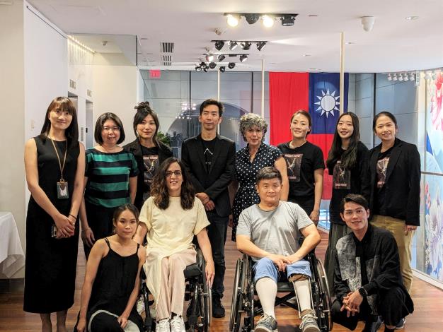 Resident Island Dance Theatre artistic director Chang Chung-an (back row, center left), and Maylis Arrabit (in wheelchair left), and members of the group pose for a photo at a press event on July 12