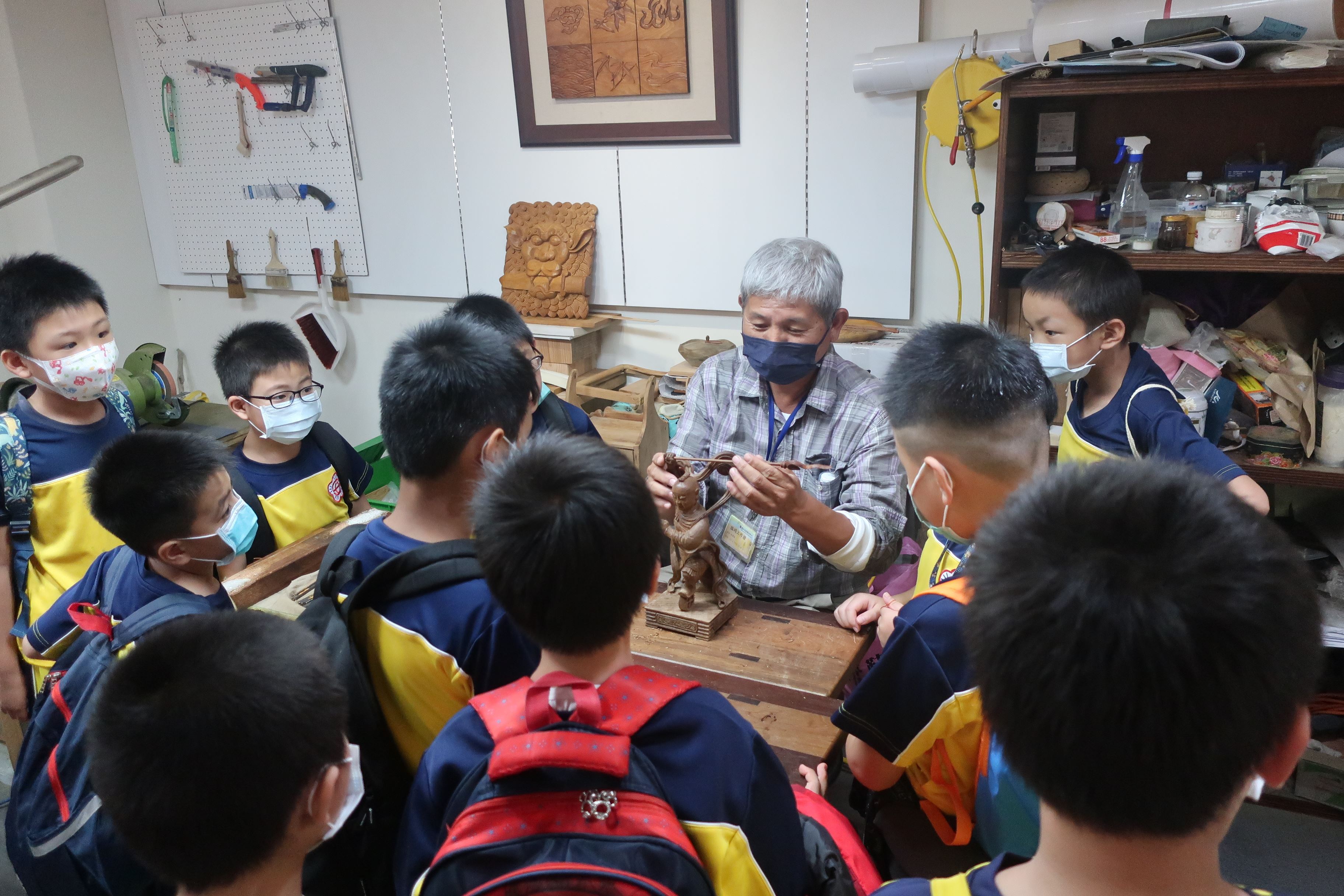 吳適為老師為學童解說傳統木雕