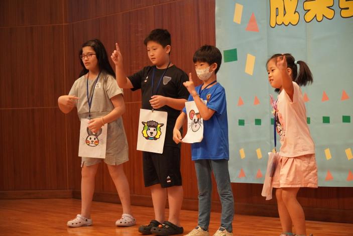 Children use the animal terms they learned at camp to tell a story in sign language.