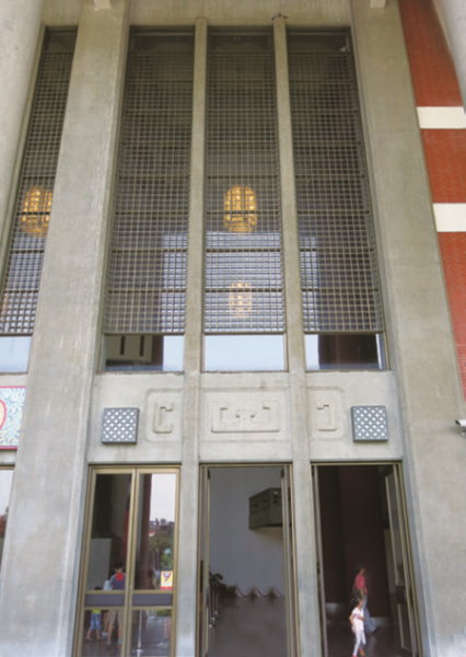 The slender solemn gate design at the façade of the building.jpg