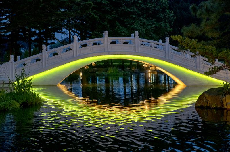 Bridge lit up at night (yellow-green)