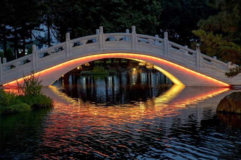 Bridge lit up at night (orange-red)